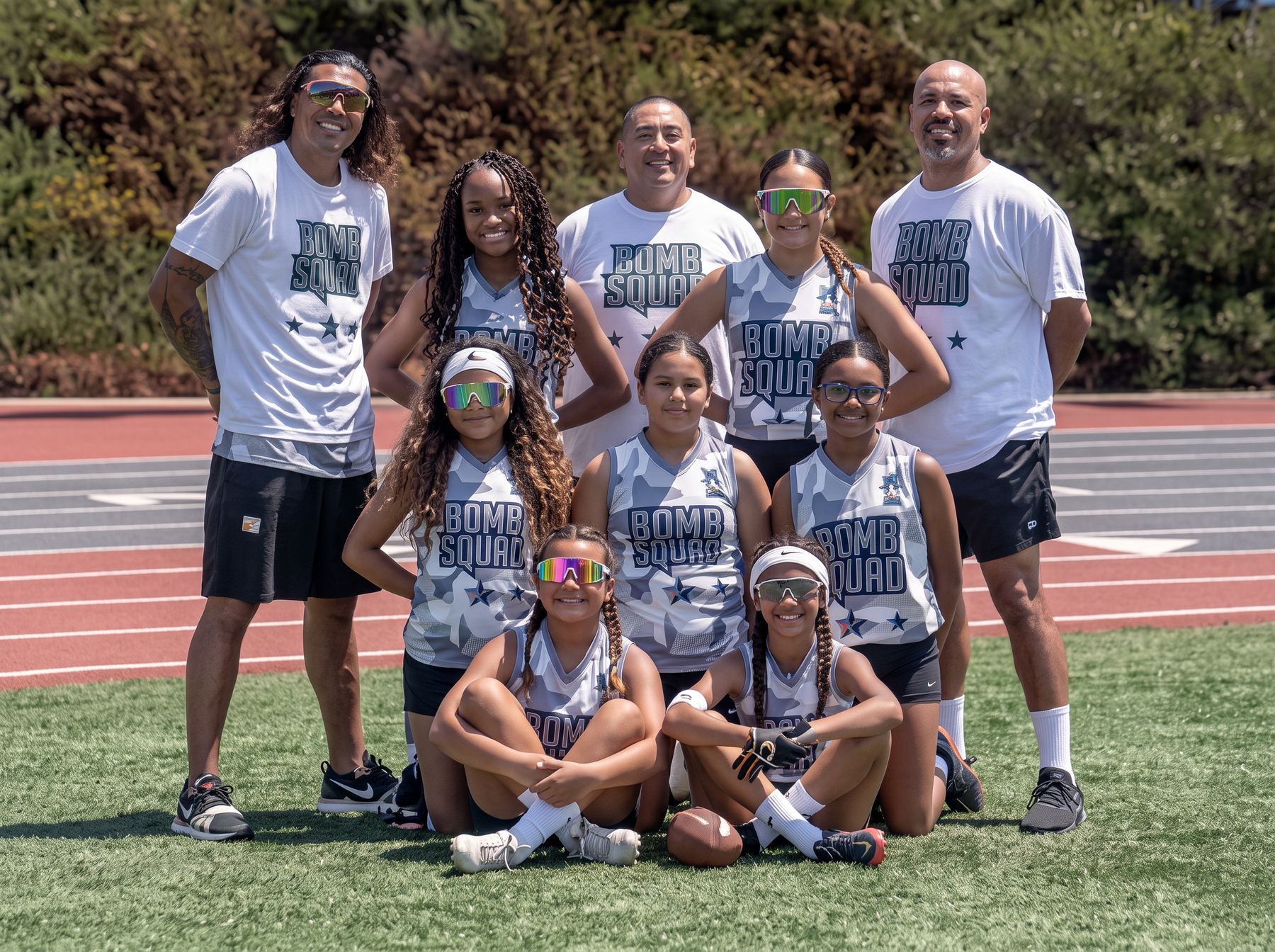 Championship flag football team photographed with their coaching staff