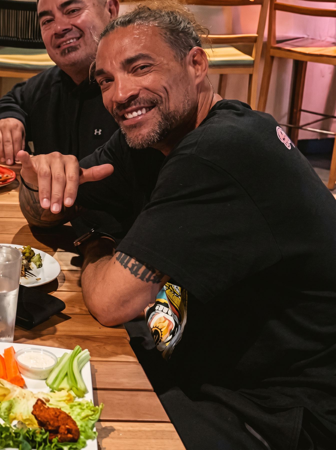 Coach Jason throwing a shaka with family and friends