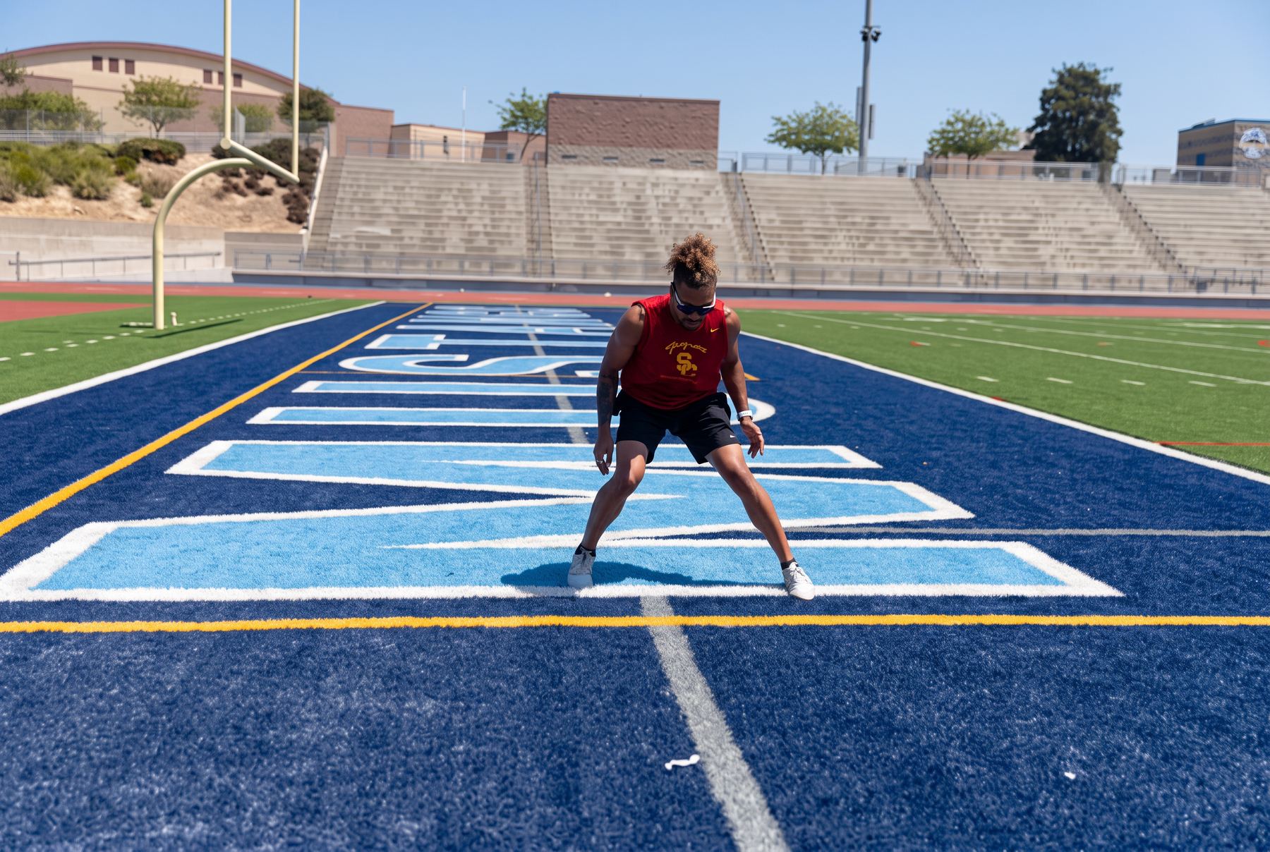Athlete sprinting through a marked lane on a stadium field